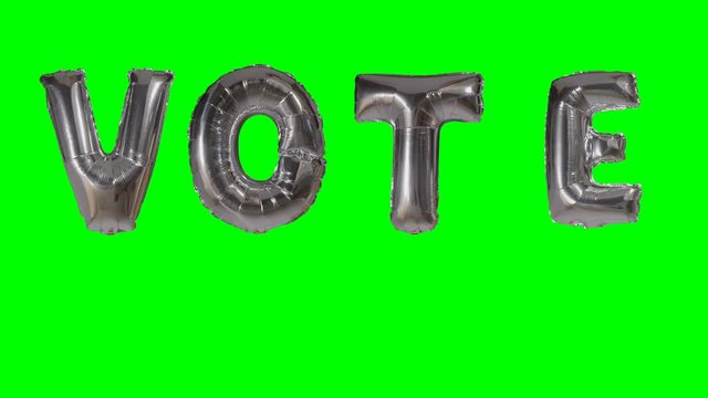 Word vote from helium silver balloon letters floating on green screen