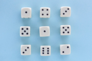White gaming dices on light blue background. victory chance, lucky. Flat lay, place for text. Top view. Close-up. Concept gamble. spectacular pastel