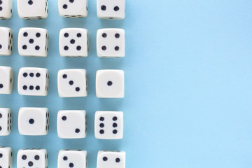 White gaming dices on light blue background. victory chance, lucky. Flat lay, place for text. Top view. Close-up. Concept gamble. spectacular pastel