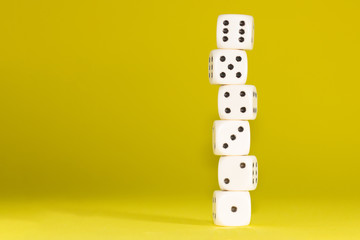 White gaming dices on pink background. victory chance, lucky. Flat lay, place for text. Top view. Close-up. Concept gamble. spectacular pastel