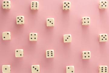 White gaming dices on pink background. victory chance, lucky. Flat lay, place for text. Top view. Close-up. Concept gamble. spectacular pastel