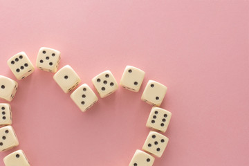 White gaming dices on pink background. victory chance, lucky. Flat lay, place for text. Top view. Close-up. Concept gamble. spectacular pastel