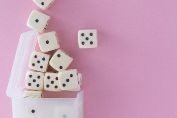 White gaming dices on violet background. victory chance, lucky. Flat lay, place for text. Top view. Close-up. Concept gamble. spectacular pastel