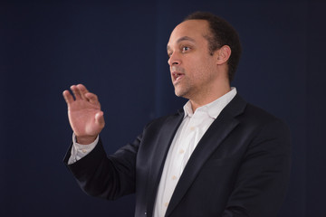 African american business coach gives presentation for businesspeople, multiracial team  at conference meeting room.