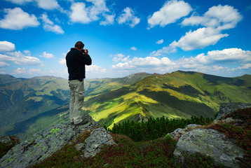 Naklejka na ściany i meble Mountain landscape hiker photographer