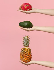 Close up set female hold in hand fresh green avocado pineapple pitahaya, dragon fruit isolated on...
