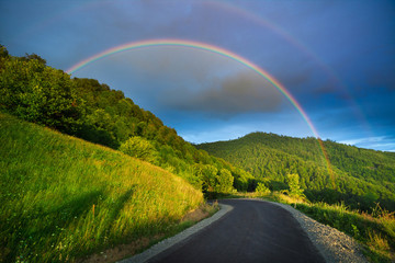 Scenic rainbow landscape on the hills in rural peaceful area