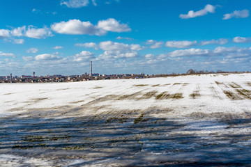 thawed patch on the field, snowy outdoor soccer field in spring low season