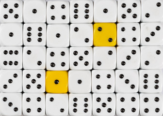Background of random ordered white dices with two yellow cubes