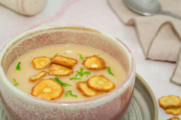 Parsnip cream soup. Delicious homemade parsnip cream soup served with parsnip chips and coriander