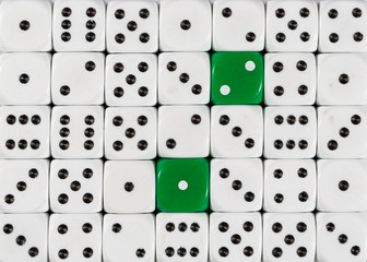 Background of random ordered white dices with two green cubes