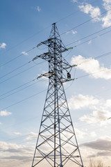 a high voltage power pylons against blue sky