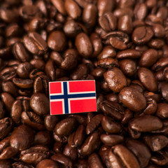 a Norway flag placed over roasted coffee beans