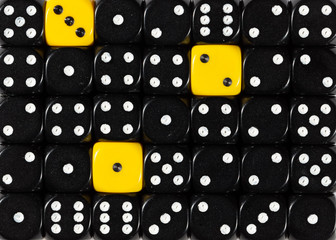 Background of random ordered black dices with three yellow cubes