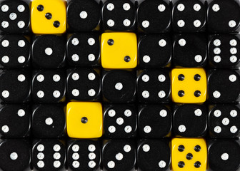 Background of random ordered black dices with five yellow cubes