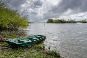 View of the river with grass and boat, in Porto do sabugueiro, muge, santarem portugal.