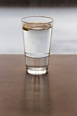 glass of water with lemon in it.