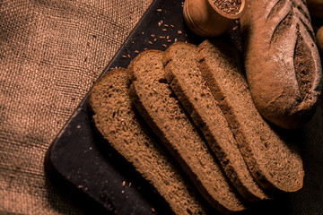 bread with cumin seeds flax dark board kitchen cooking table dark taste flavor