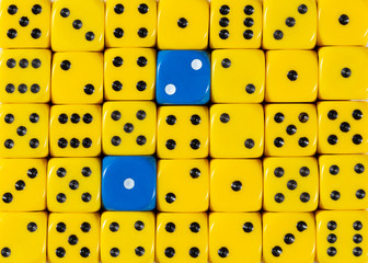 Background of random ordered yellow dices with two blue cubes