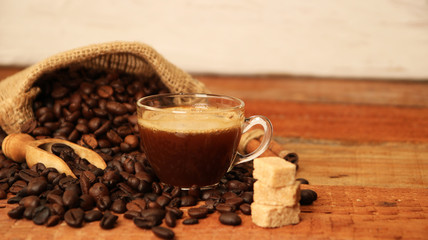Coffee cup with Coffee beans, burlap sack and with cinnamon sticks