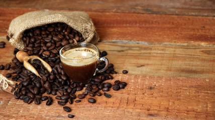 Coffee cup with Coffee beans, burlap sack and with cinnamon sticks