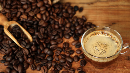 Coffee cup with Coffee beans, burlap sack and with cinnamon sticks
