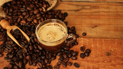 Coffee cup with Coffee beans, burlap sack and with cinnamon sticks