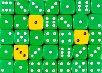 Background of random ordered green dices with three yellow cubes