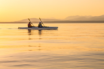 People independent strong women sea kayaking together. Active outdoor adventure water sports. Teamwork, progress, journey concepts.