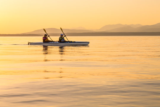People independent strong women sea kayaking together. Active outdoor adventure water sports. Teamwork, progress, journey concepts.