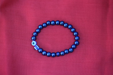 White gold diamond ring on top of colored stones. Romantic background ( Valentine's Day) 