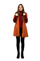 Full-length shot of Young woman with coat with surprise facial expression on isolated white background