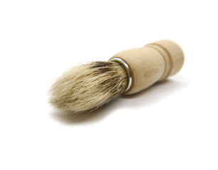Natural shaving brush with wooden bristle handle isolated on white background.