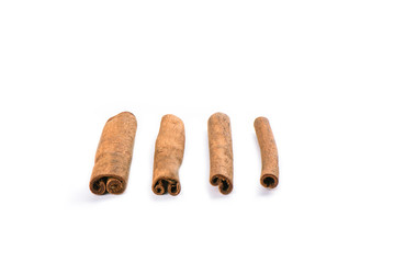 Four cinnamon sticks isolated on white background. Spice concept.