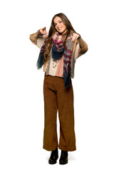 Full-length shot of Young hippie woman points finger at you while smiling on isolated white background