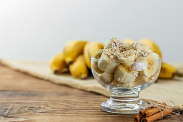 Fototapeta premium close up on glass jar with pieces of banana with oats