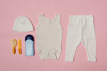 Baby fashion concept on a pink background. Clothing and accessories for care.
