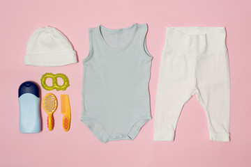 Baby fashion concept on a pink background. Clothing and accessories for care.