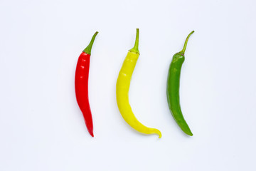 Different colors chili peppers isolated on white.