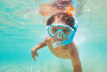 Happy kid boy snorkeling in clear blue sea - obrazy, fototapety, plakaty