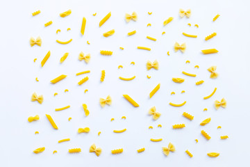 Different types of dry pasta on white.