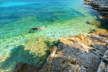 Scenic view of Emplisi Beach, picturesque stony beach in a secluded bay, with clear waters popular for snorkelling. Small pebble beach near Fiscardo town of Kefalonia, Greece.