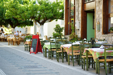 Small outdoor restaurants at the pedestrian area at center of Kalavryta town near the square and odontotos train station, Greece.
