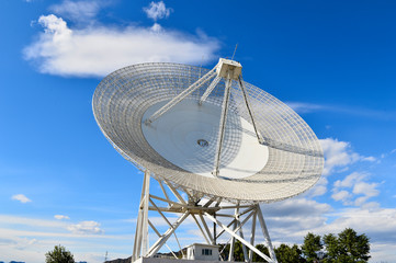 Array of satellite dishes or radio antennas against sky. Space o
