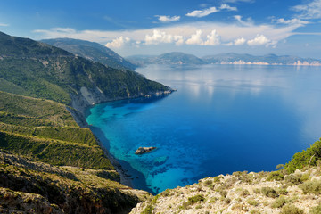 Naklejka na ściany i meble Scenic aerial view of picturesque jagged coastline of Kefalonia with clear turquoise waters, surrounded by steep cliffs.