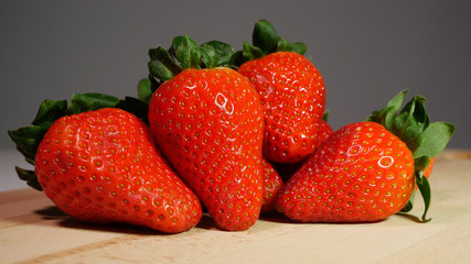 Group shot of strawberries on natural wooden table