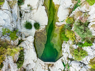 Papingo Rock Pools, also called ovires, natural green water pools located in small smooth-walled gorge near the village of Papingo in Zagori region, Greece.