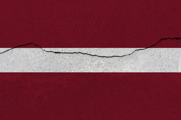 latvia flag on concrete wall with crack