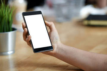 Girl with a blank screen mobile smartphone in her hand.
