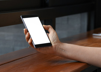 Female hand holding a smartphone blank screen,close-up shoot.